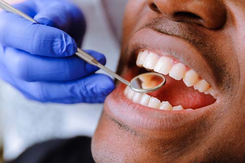 emergency-dental-services (3) man receiving emergency dental services