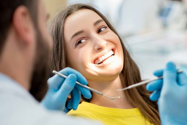 how-to-prevent-teeth-shifting (6) dentist working on a patient to prevent teeth shifting