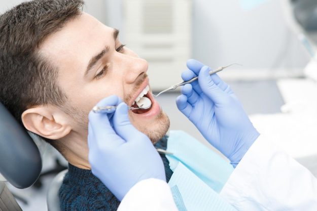 Treating a Chipped Tooth man being treated for a chipped tooth