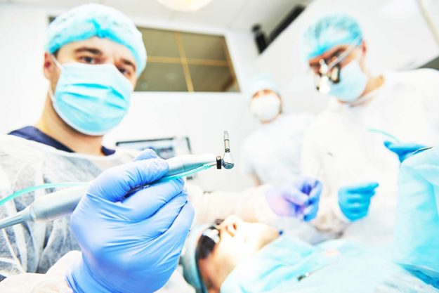 dental-implants dentist putting in dental implants
