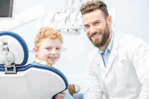 dentist performing dental bonding services on a child