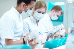 dentists performing a tooth extraction