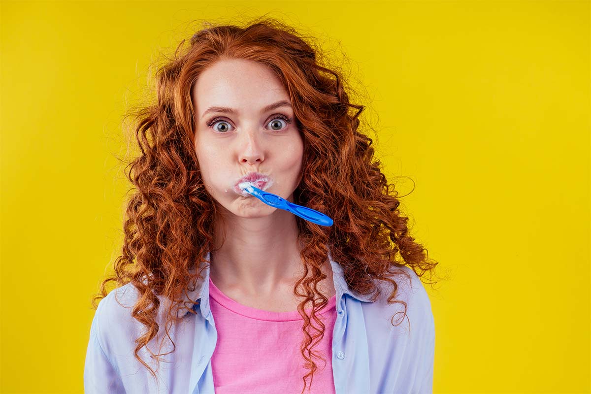 Woman Brushing Teeth To Care For Dental Health