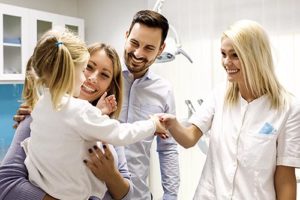 parents with daughter learning about family dentistry 